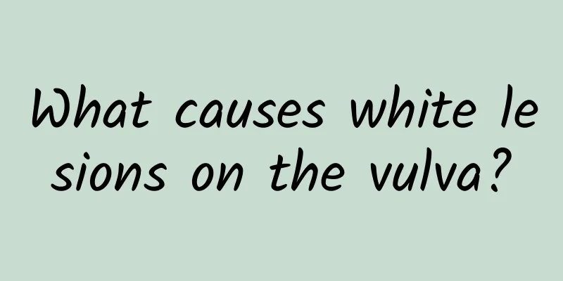 What causes white lesions on the vulva?